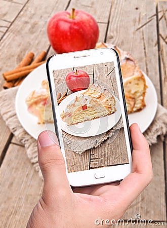 Hands taking photo apple cake with smartphone