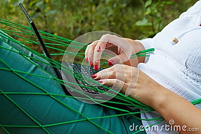 Hands of woman, who works on notebook