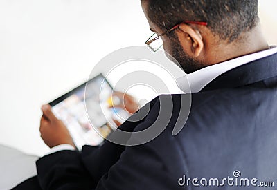 Handsome African man with tablet computer