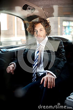 Handsome business corporate inside taxi cab