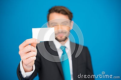 Handsome businessman showing blank business card