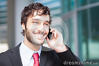 Handsome businessman talking on the phone