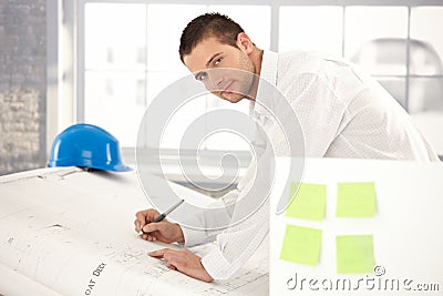 Handsome engineer drawing plans