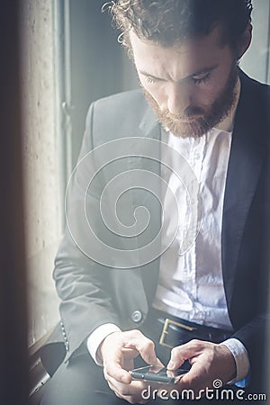 Handsome hipster elegant man on the cellphone