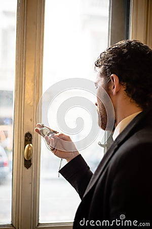 Handsome hipster elegant man with pocket watch