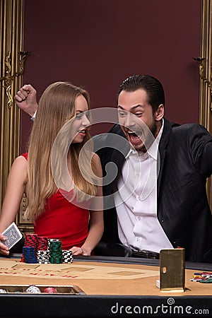Handsome man and beautiful woman in casino