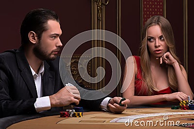 Handsome man and beautiful woman in casino