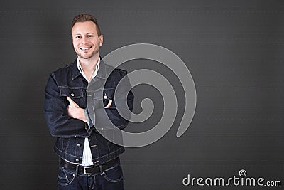 Handsome man with crossed arms - man isolated on black backgroun