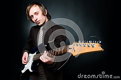 Handsome man playing electro guitar