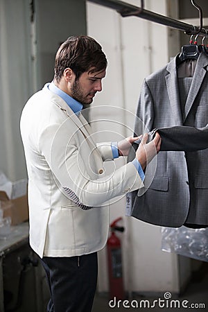 Handsome man shopping for clothes at a store.