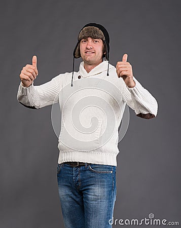 Handsome man in winter hat showing ok sign