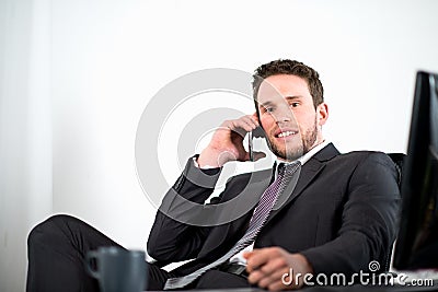 Handsome young executive business man in office