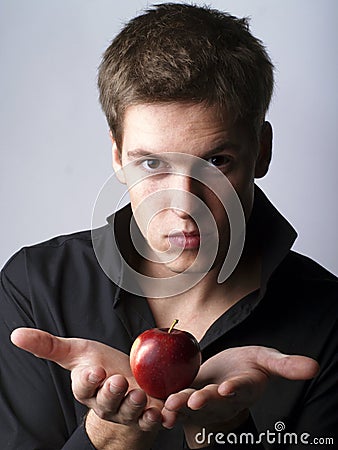 Handsome young male model holding an apple