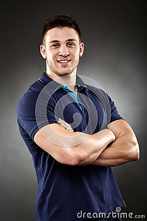 Handsome young man with arms folded