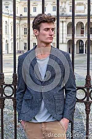 Handsome young man outside elegant palace