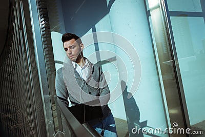 Handsome young man working at computer and listening to music