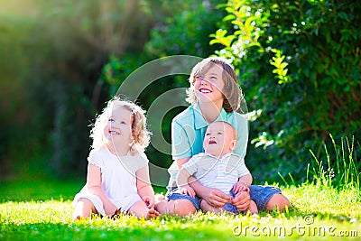 Happy adorable kids in the sunny garden