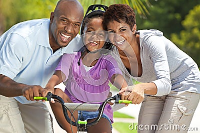 Happy African American Family & Girl Riding Bike