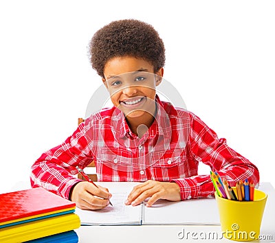 Happy African American school boy taking test