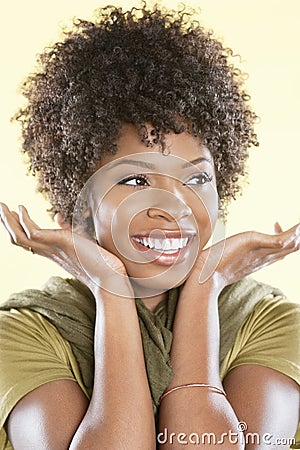 Happy African American woman looking away over colored background