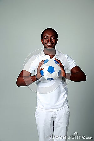 Happy african man holding soccer ball