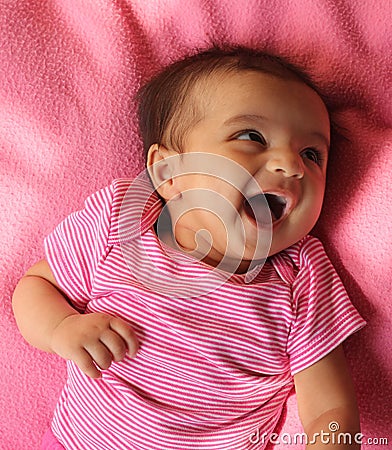 Happy asian baby girl in pink cloths