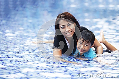 Happy Asian family at swimming pool