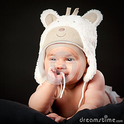 Happy baby in bear cap