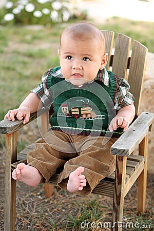 Happy baby boy on wood lawn chair