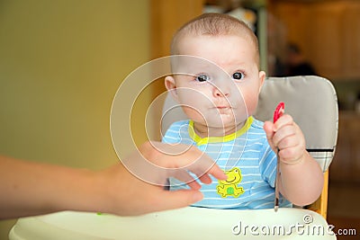 Happy baby infant boy eating meal