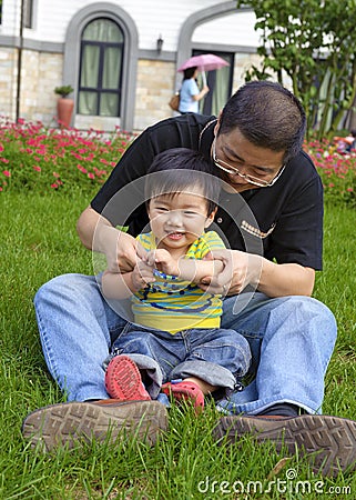 Happy baby is playing with his father