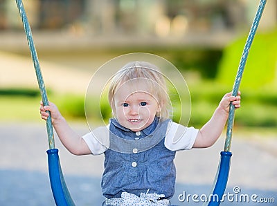 Happy baby sitting on swing