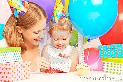 Happy birthday. mother giving gift to his little daughter with balloons