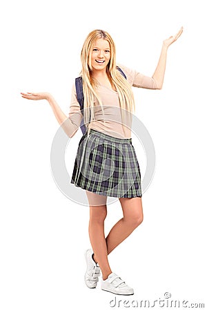 Happy blond female student with raised hands