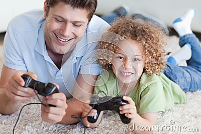 Happy boy and his father playing video games