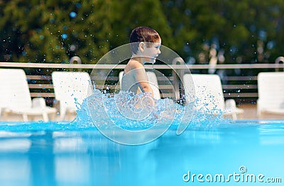 Happy boy jumping in the pool