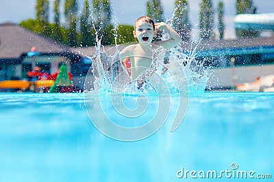 Happy boy kid jumping in the pool