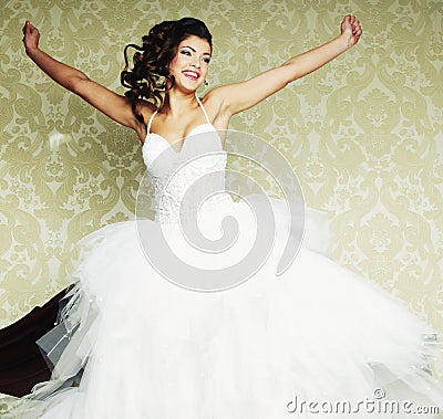 Happy bride jump on bed.