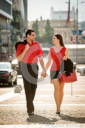 Happy business couple walking street