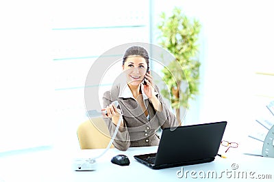 Happy business woman on phone call at office