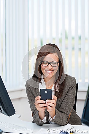 Happy business woman using a smartphone