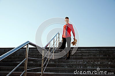 Happy businessman come down the stairs
