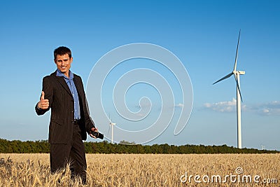 Happy businessman in a field