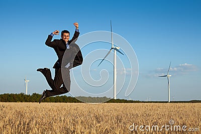 Happy businessman in a field