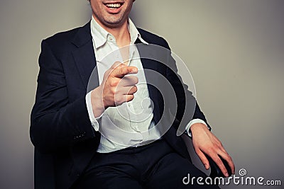 Happy businessman laughing and pointing