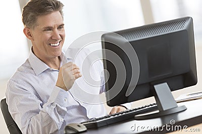 Happy Businessman Looking At Computer Monitor