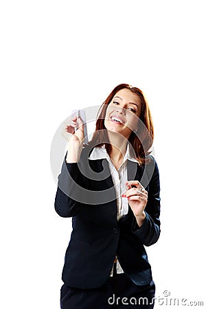 Happy businesswoman holding paper plane