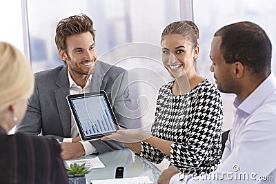 Happy businesswoman holding tablet computer