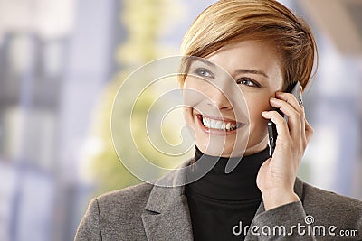 Happy businesswoman talking on mobile outdoors