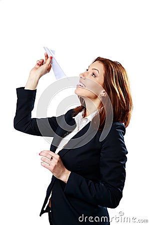 Happy businesswoman throwing paper plane